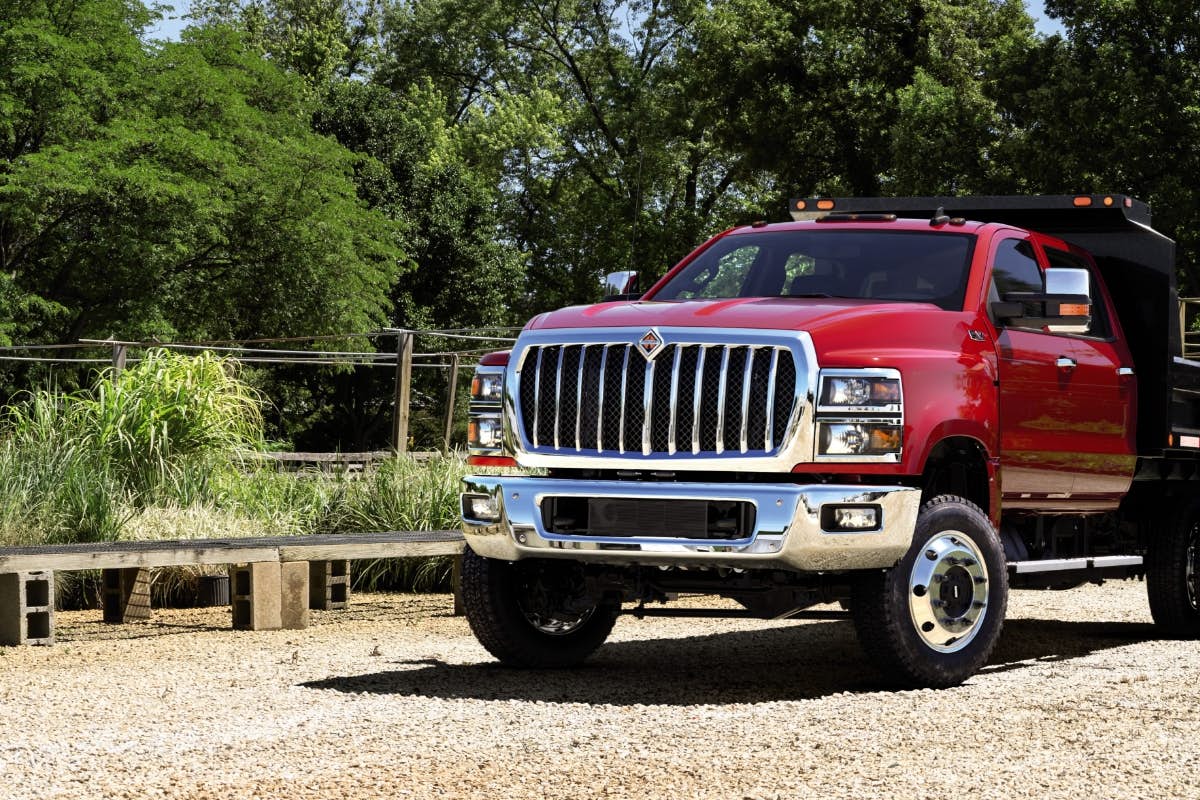 A red truck parked on gravel